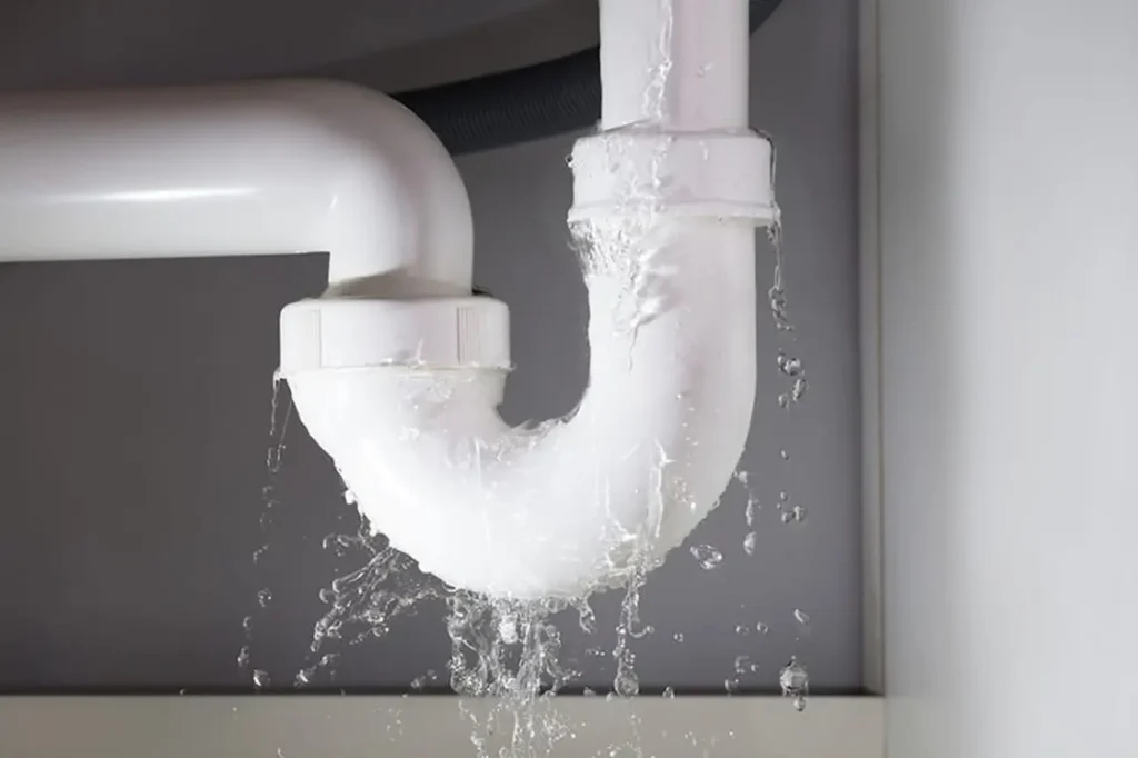 Leaking pipe under a sink for Taylor Plumbing South Auckland showing urgent 24 hour emergency plumbing service